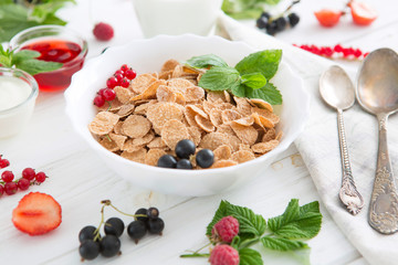 Healthy tasty breakfast multigrain wholewheat healthy cereals with strawberries, raspberries, black currants and red currants.