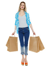 Front view of a woman walking with shopping bags.