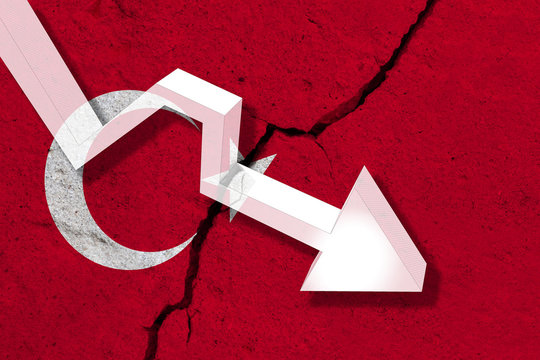 Turkey Flag on the cracked wall with arrow falling down. Concept of decrease in the country.