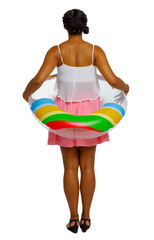 Back view of African American woman on the beach with inflatable circle.