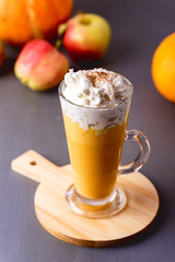 Cup of Tasty Honey Pumpkin Spice Latte with Whipped Cream Autumn Beverage Vertical Gray Background