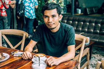 Man sitting in coffee shop for drink in coffee time