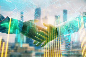 Double exposure of financial chart and world map on cityscape background with two businessmen handshake. Concept of international investment