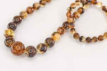 Unique pieces of transparent yellow amber on a white background.