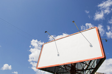 Blank billboard against the blue sky in a residential area