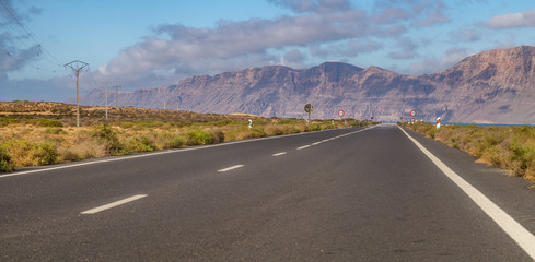 Tourist, scenic road to Lanzarote, leading to the ocean