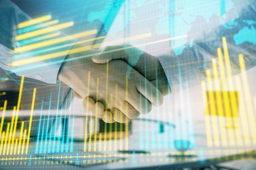 Multi exposure of financial chart and map on office background with two businessmen handshake. Concept of success in business