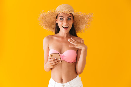 Attractive cheerful young girl wearing bikini standing