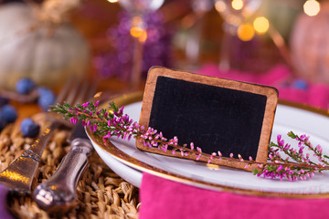 Ambient autumn place setting with blank chalk board for text message