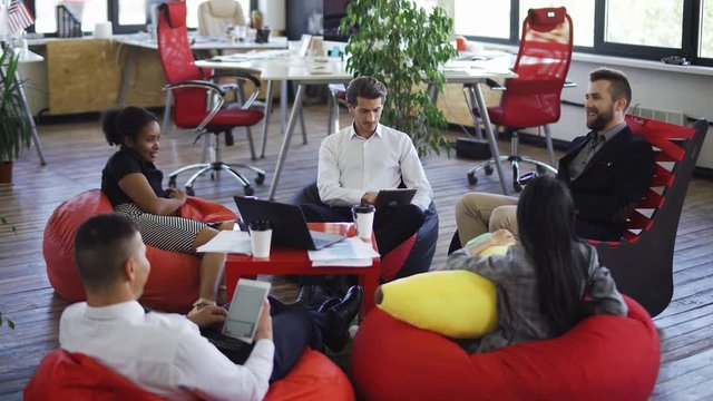 international teamwork in modern office, mans and womans managers talks and communicate, office workers team building.