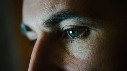 Close-up of a Green-Blue Man's Eyes with Screen Reflecting in Them. - Powered by Adobe