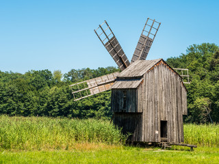 Fototapeta na wymiar Old Wooden Grain Windmill ( Gristmill ) Landscape