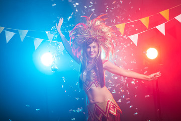 Carnival, belly dance and holiday concept - Beautiful female samba dancer wearing gold costume and smiling