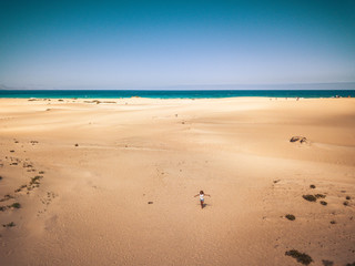 Standing happy girl on beach with ocean in. background - happiness and freedom for tourist people at the sea - concept of travel and enjoy the outdoor leisure nature activity - tropical vacation