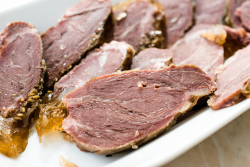 Smoked Meat Veal Cheek Slices on Wooden Board. Ready to Eat.