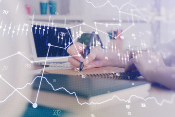 Financial graph displayed on woman's hand taking notes background. Concept of research. Double exposure