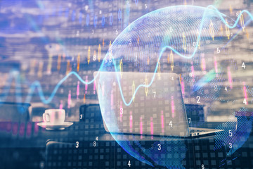 Double exposure of chart and financial info and work space with computer background. Concept of international online trading.