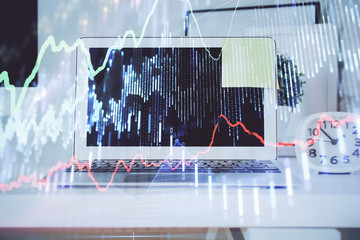 Stock market graph and table with computer background. Double exposure. Concept of financial analysis.