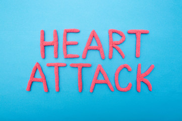 Inscription Heart attack on a blue background concept of myocardial infarction and heart muscle, brain, cardiology