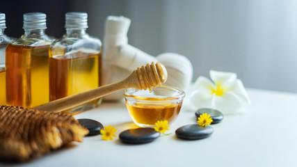 Closeup on honey spa therapy ingredients and salt spa objects on table,wellness and relaxation concept