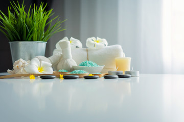 Thai spa massage compress balls and salt spa objects on table background, wellness and relaxation concept
