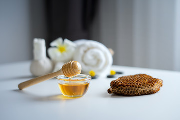 Closeup on honey spa therapy ingredients and salt spa objects on table,wellness and relaxation...