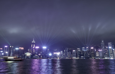 Fototapeta na wymiar Light show in the sky over skyscrapers in Hong Kong at night