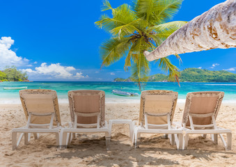 chairs and umbrella on the beach of seychelles 