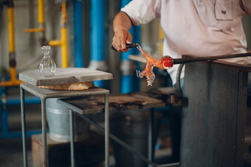 Glass blower artist  crafter forming piece of glass. Murano and Burano, Italy.