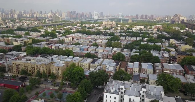 Drone over Bronx with Manhattan skyline bridge background
