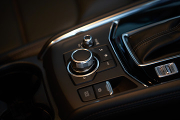 Vehicle interior of a modern car with media and navigation control buttons