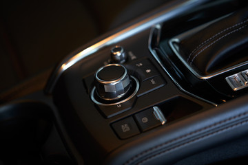 Vehicle interior of a modern car with media and navigation control buttons