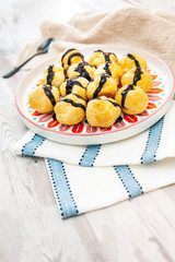Profiterole with vanilla and chocolate sauce