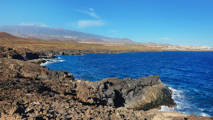 The coastal walk between Montana Amarilla and Amarilla Golf resort, a perfect solitary hiking path with stunning vistas inland towards Teide peak and towards Atlantic, Tenerife, Canary Islands, Spain
