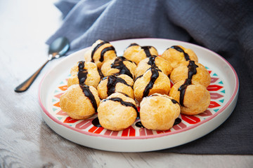 Profiterole with vanilla and chocolate sauce