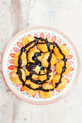 Profiterole with vanilla and chocolate sauce