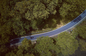 Aerial view of the forest on country road motorcycle rider , Malaysia .