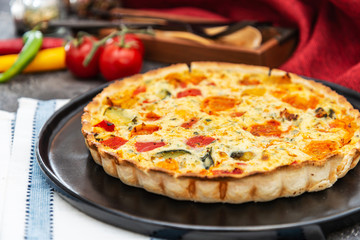 vegetable pie with cherry tomatoes, grilled peppers and courgettes with fresh eggs and fresh cream