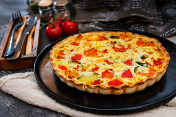 vegetable pie with cherry tomatoes, grilled peppers and courgettes with fresh eggs and fresh cream