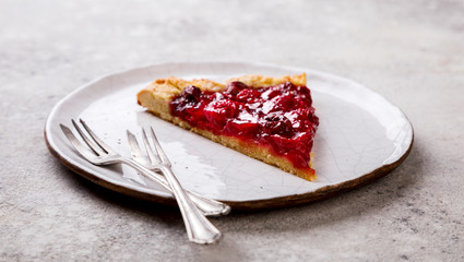 Bakery products. Summer pie with berries. Galeta with cherries sprinkled with powdered sugar.