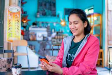 Portrait of Asia women using smartphone in coffee shop