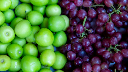 Close up green jujube and grape fruit in the basket