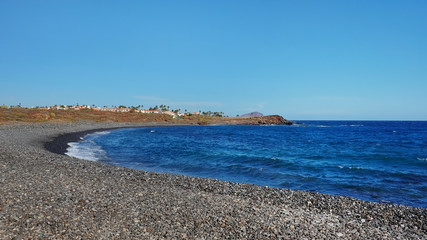 Empty pebble beach close to Amarilla Golf resort, beautiful and solitary seascape views typical to the coastal trail between Montana Amarilla and Amarilla Golf resort, Tenerife, Canary Islands, Spain