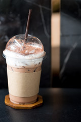 Iced coffee mocha with foam milk in takeaway cup