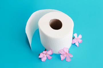 white toilet paper roll with flowers decor on a blue background