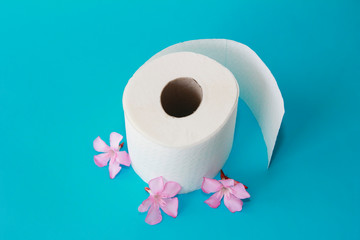 white toilet paper roll with flowers decor on a blue background