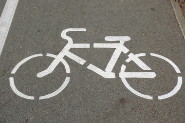 white road sign on the pavement