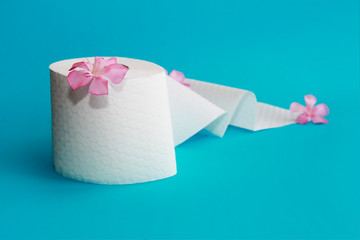 white toilet paper roll with flowers decor on a blue background