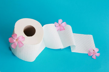 white toilet paper roll with flowers decor on a blue background