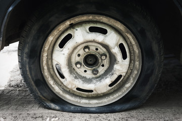 Obraz premium Flat tire. Punched wheel on a car. Close-up